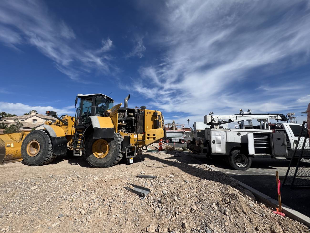 Wheel loader with engine panels open beside the ADSW Repair service truck during an on-site repair in Las Vegas